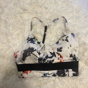 NWOT. Nike sports bra size medium. With a cute open back. Cute flower design.